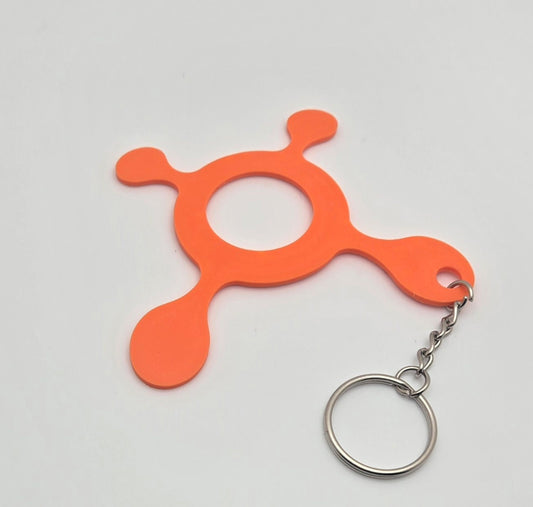 Orange 3D printed splat keychain with metal key ring on a white background